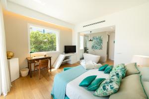 מיטה או מיטות בחדר ב-Unìco Boutique Hotel d'Arte