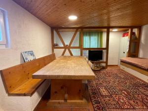 Cette chambre comprend une table en bois. dans l'établissement Casa Acacia con giardino, à Avegno