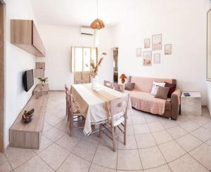 a living room with a table and a couch at Casa Tairsia in Torre Lapillo