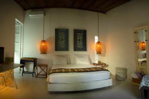 a bedroom with a bed and two lamps and a table at Ekaa Hotel in Palomino +37 photos