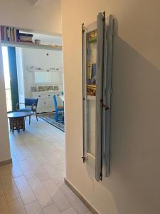 a glass refrigerator in a kitchen with a table at casa del parco vista mare in Trapani