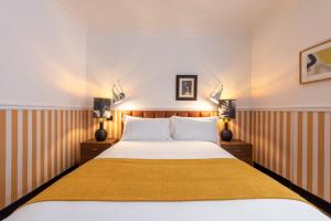 a bedroom with a large bed and two lamps at The Couper Spiga in Milan