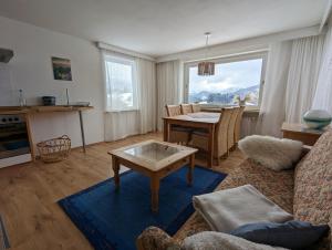 a living room with a table and a dining room at Haus Edelweiss Jungholz in Jungholz