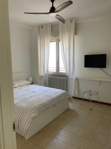 a bedroom with a bed and a flat screen tv at Viale Pascoli Due in Cesenatico