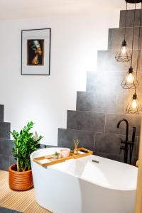 a bathroom with a white tub in a room at Thome Ego Flat in Cluj-Napoca