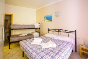 a bedroom with two bunk beds with white shoes on them at A due passi dal Mare in Riomaggiore +10 photos