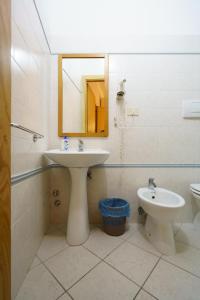a bathroom with a sink and a toilet and a mirror at A due passi dal Mare in Riomaggiore