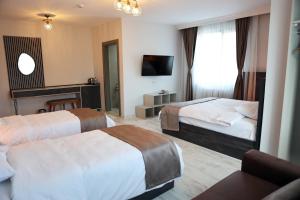 A bed or beds in a room at SAR-PER Hotel