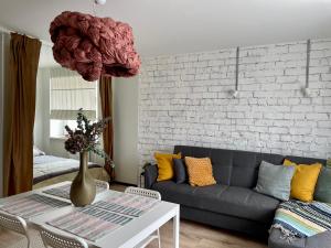 a living room with a couch and a table at M a t c h a in Ventspils