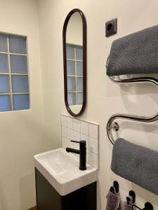 a bathroom with a sink and a mirror at M a t c h a in Ventspils +22 photos
