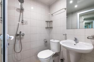 a bathroom with a toilet and a sink and a shower at Jazz & Wine - Luxury apARTment By The Sea & Parking & HBO & Netflix in Varna City +49 photos
