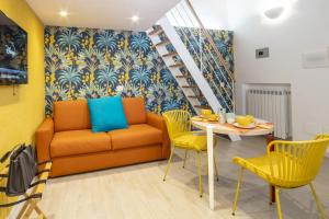 a living room with a couch and a table and chairs at La Casetta a Sorrento in Sorrento