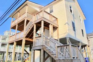a large house with wooden balconies on the side of it at Endless Summer in Carolina Beach
