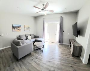 a living room with a couch and a ceiling fan at Beachwood Bungalow A in Carolina Beach