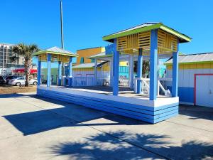 a building with a pavilion in a parking lot at Beachwood Bungalow A in Carolina Beach