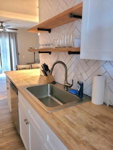 a kitchen with a sink and a counter top at Beachwood Bungalow A in Carolina Beach