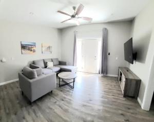 a living room with a couch and a tv at Beachwood Bungalow B in Carolina Beach