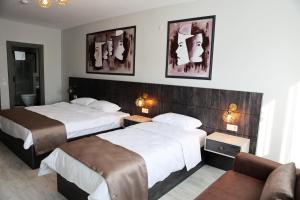 A bed or beds in a room at SAR-PER Hotel