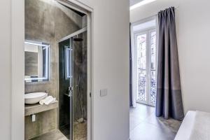 a bathroom with a sink and a glass shower at Gallery Suite Naples in Naples