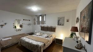 a bedroom with a bed and a table with a lamp at Fiera di Roma B&B in Ponte Galeria