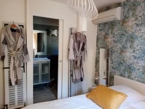 a bedroom with a bed and a mirror at Au Mas Saint Pierre in Pignans