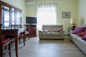 a living room with a couch and a table at Alloggi Villa Sarsina in Anzio