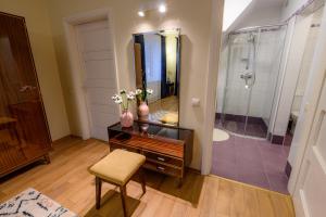 a bathroom with a vanity and a shower with a mirror at Zofija in Birštonas