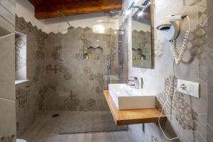 a bathroom with a sink and a shower at La Casetta a Sorrento in Sorrento