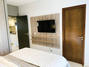 a bedroom with a bed and a flat screen tv at Santa Fe STAR -Cochera xa autos in San Miguel de Tucumán