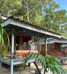 una casa de madera con un banco delante en Good Time Resort Koh Kood en Ban Lak Uan