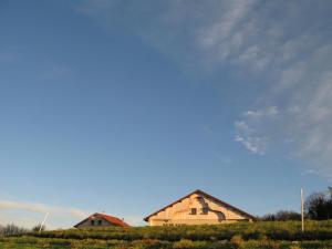 a barn in a field with a blue sky at Ferme-Auberge du Rondeau in Lavans-Vuillafans