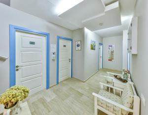 a hallway with white walls and blue doors at Hotel Sonne - Adults Only in Kaş