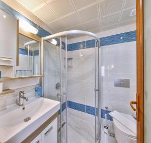 a bathroom with a shower and a sink and a toilet at Hotel Sonne - Adults Only in Kaş