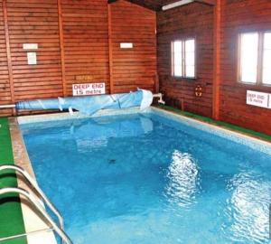 a large swimming pool in a building at 3 bed caravan in Kirkcolm