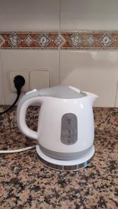 einen Wasserkocher mit weißem Tee auf einer Theke in der Unterkunft Apartamento Ca la Raquel Calella Palafrugell in Calella de Palafrugell