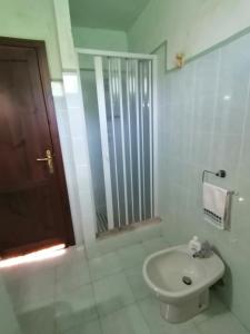 een witte badkamer met een toilet en een douche bij My Nest in Arzachena