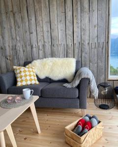 a living room with a couch and a table at Raaum Gard, hytte 2 in Hafslo +6 photos