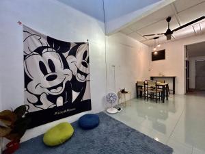 a living room with a large banner on the wall at Cozy24#4pax#wifi&netflix#NearAeonAlma#Heritage in Bukit Mertajam