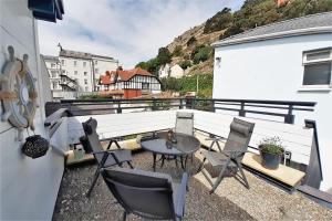 a balcony with chairs and a table and a building at The Penthouse in Llandudno