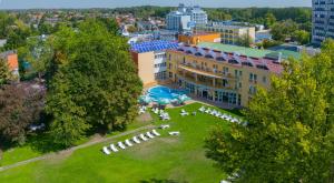 an aerial view of a hotel with a park at Hunguest Hotel Apollo in Hajdúszoboszló