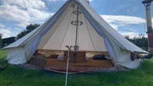 a large white tent in a field of grass at Home Farm Radnage Glamping Bell Tent 1, with Log Burner and Fire Pit in Radnage