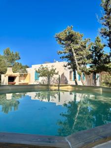 a pool of water in front of a house at Casa Rustick in Sant Francesc Xavier