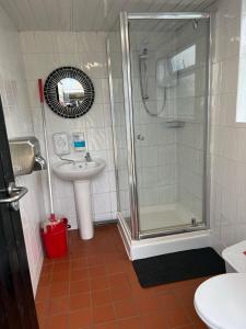 a bathroom with a shower and a sink at Home Farm Radnage Glamping Bell Tent 1, with Log Burner and Fire Pit in Radnage