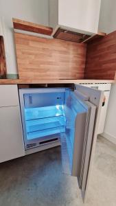 an empty refrigerator with its door open in a kitchen at El 34 in Lorca