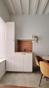 a kitchen with a white refrigerator and a table at El 34 in Lorca