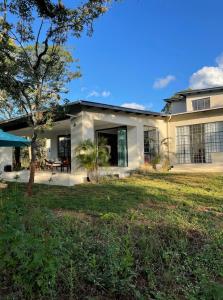 a house with a large yard at Leopards Hill, Lusaka family home in beautiful nature in Mwambula +10 photos