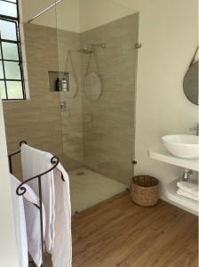 a bathroom with a shower and a sink at Leopards Hill, Lusaka family home in beautiful nature in Mwambula