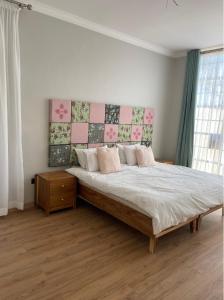 a bedroom with a large bed with a headboard at Leopards Hill, Lusaka family home in beautiful nature in Mwambula