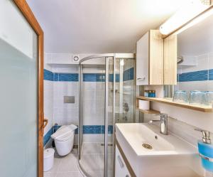 a bathroom with a shower and a sink and a toilet at Hotel Sonne - Adults Only in Kaş