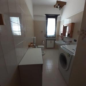 a bathroom with a washing machine and a sink at B&B Villa Rosalia in Barrafranca